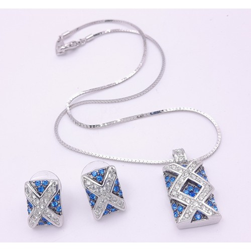 1445 - A matching set of earrings and necklace featuring blue and white stones arranged in a criss-cross pa... 