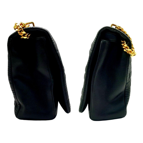 108 - A Burberry Black Leather Hand/Shoulder Bag. Textured exterior with gold tone hardware including curb... 