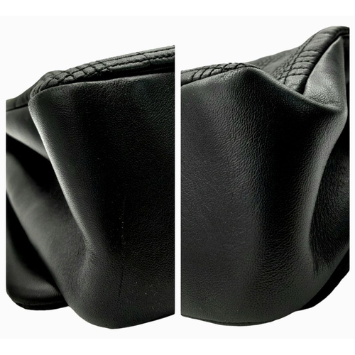 108 - A Burberry Black Leather Hand/Shoulder Bag. Textured exterior with gold tone hardware including curb... 