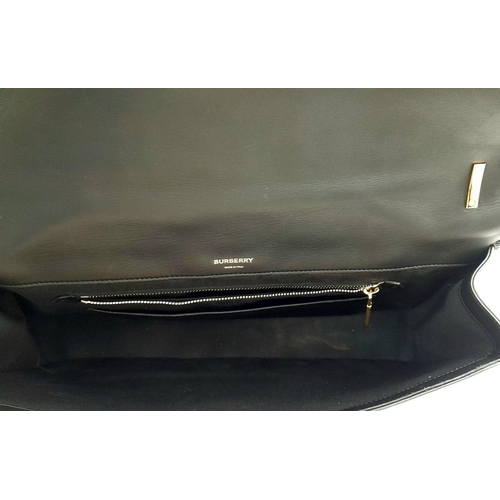 108 - A Burberry Black Leather Hand/Shoulder Bag. Textured exterior with gold tone hardware including curb... 