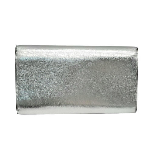 115 - A Yves Saint Laurent Silver Effect Leather Belle de Jour Clutch Bag. Dust cover. Dark textile and le... 