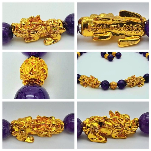 147 - A Chinese, amethyst necklace and earrings set with gold plated fu dogs and “good luck” charms. In a ... 