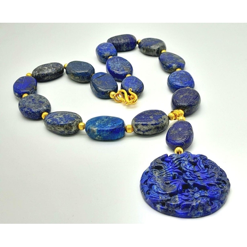 175 - A very substantial, lapis lazuli necklace with a highly detailed carved pendant with a naturalistic ... 