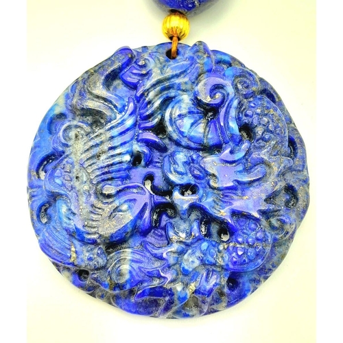 175 - A very substantial, lapis lazuli necklace with a highly detailed carved pendant with a naturalistic ... 