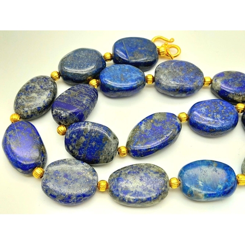 175 - A very substantial, lapis lazuli necklace with a highly detailed carved pendant with a naturalistic ... 