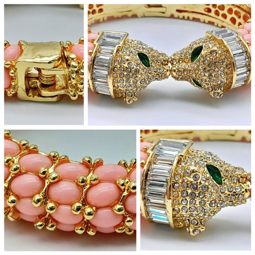 182 - A head-turning, gold plated bracelet with two panther heads adored with cubic zirconia and green eye... 