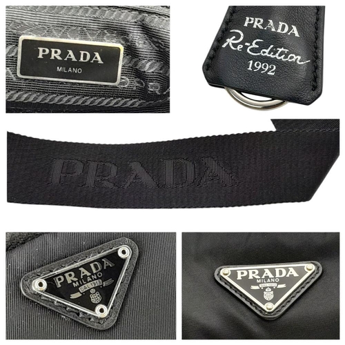 192 - A Prada Black Nylon Tote Bag. Prada badge exterior. Textile interior with zipped and open compartmen... 