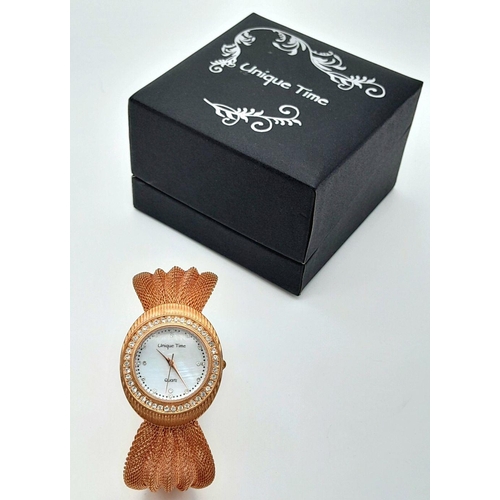 196 - A very feminine, rose gold plated, UNIQUE TIME ladies watch. Case 34 mm, bezel studded with cubic zi... 