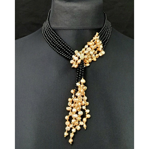 203 - A long, three strand, black onyx and cream coloured Keshi pearl necklace that can be worn in several... 