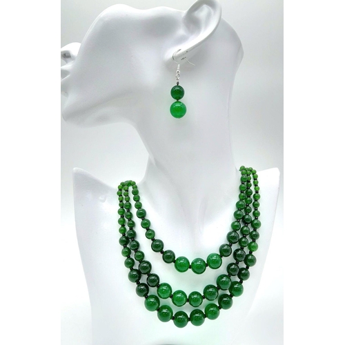 231 - An Oriental green jade necklace, with one to three strands and earrings set. Necklace Length: 50 cm,... 