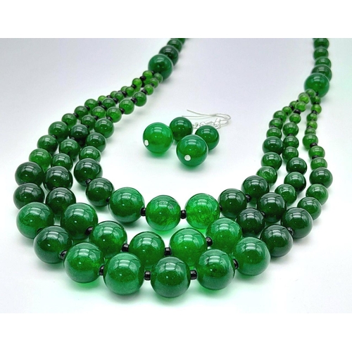 231 - An Oriental green jade necklace, with one to three strands and earrings set. Necklace Length: 50 cm,... 