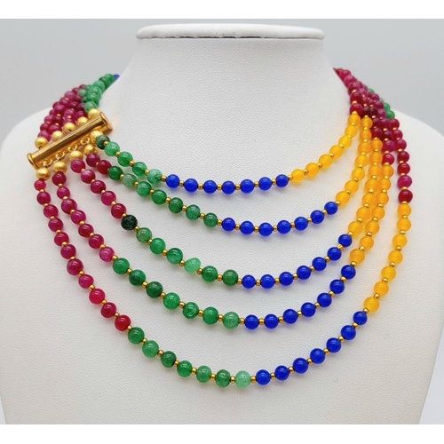 238 - A five multi gem strand necklace with gold plated parts. Length: 57-71 cm, weight: 84 g.