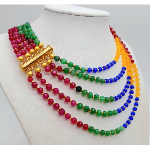 238 - A five multi gem strand necklace with gold plated parts. Length: 57-71 cm, weight: 84 g.