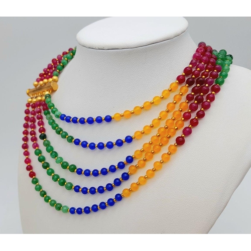 238 - A five multi gem strand necklace with gold plated parts. Length: 57-71 cm, weight: 84 g.