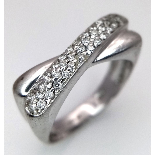 246 - A 9K White Gold Diamond Crossover Ring. Three rows of small round cut diamonds. Size N 1/2. 4.7g tot... 