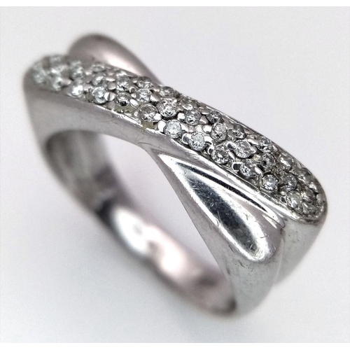 246 - A 9K White Gold Diamond Crossover Ring. Three rows of small round cut diamonds. Size N 1/2. 4.7g tot... 