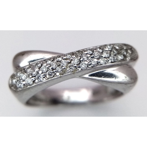 246 - A 9K White Gold Diamond Crossover Ring. Three rows of small round cut diamonds. Size N 1/2. 4.7g tot... 