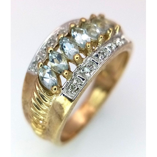 253 - A 9K Yellow Gold Aquamarine and Diamond Ring. Marquise shaped aqua between two rows of diamonds. Siz... 