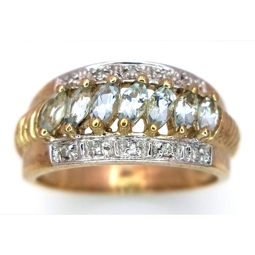 253 - A 9K Yellow Gold Aquamarine and Diamond Ring. Marquise shaped aqua between two rows of diamonds. Siz... 