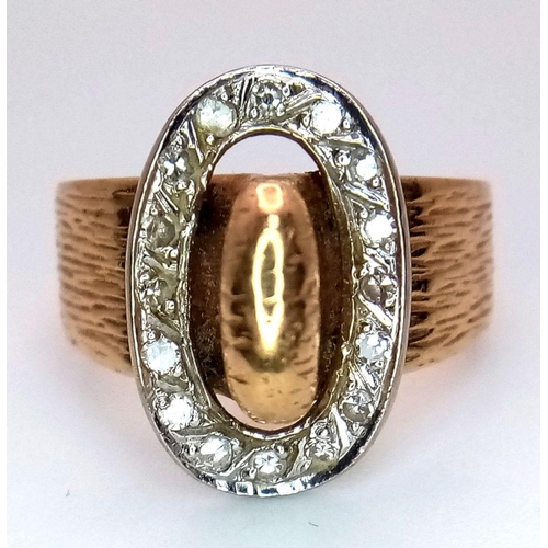 345 - A 9K Yellow Gold and Diamond Belt Buckle Ring. Oval diamond surround. Size O. 7.25g total weight.