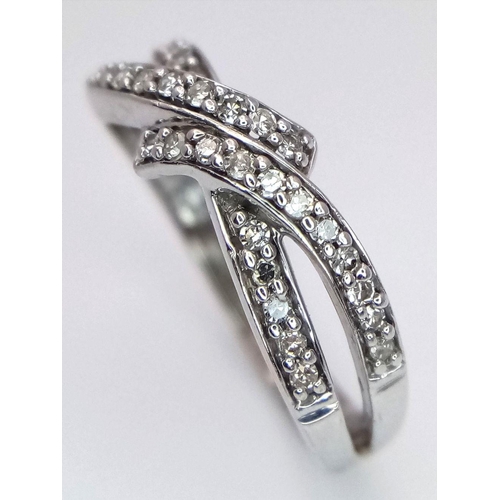 351 - A 9K White Gold Diamond Crossover Ring. 0.27ctw diamonds. Size N. 2.66g total weight.