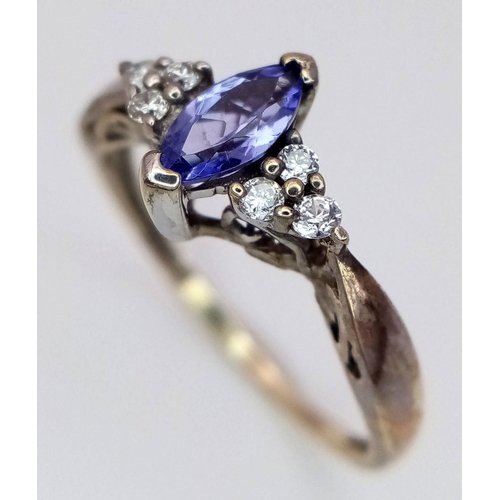 358 - A Tanzanite and Diamond 9K Gold Ring. Size L. 1.5g total weight.