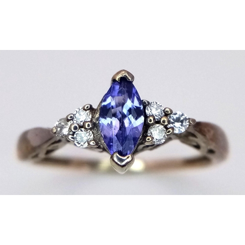 358 - A Tanzanite and Diamond 9K Gold Ring. Size L. 1.5g total weight.