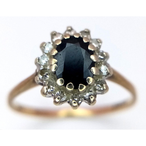 379 - A 9K Yellow Gold Sapphire and Diamond Ring. Central sapphire with a diamond surround. Size L. 1.55g ... 