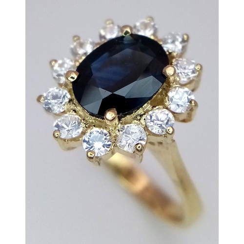 386 - A Gorgeous 14K Yellow Gold Sapphire and White Zircon Ring. 
A 2.5ct central sapphire with a gorgeous... 