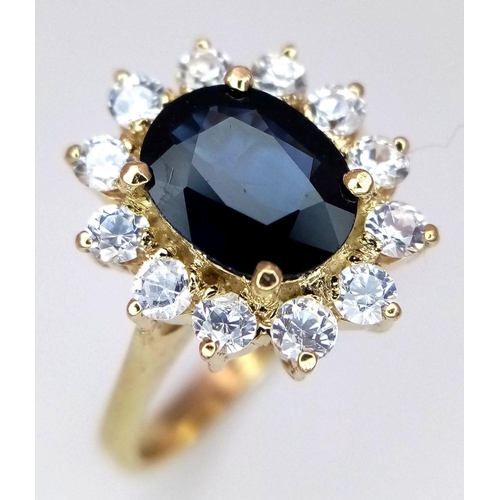 386 - A Gorgeous 14K Yellow Gold Sapphire and White Zircon Ring. 
A 2.5ct central sapphire with a gorgeous... 