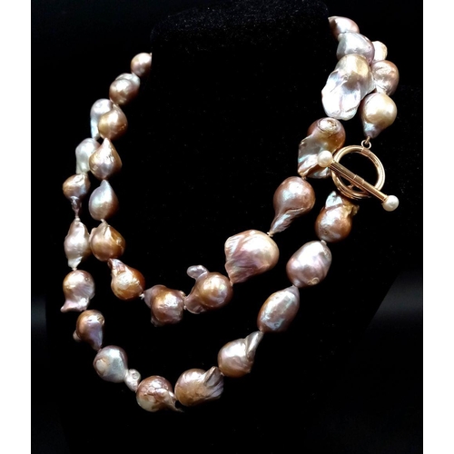 46 - A Vintage Matinee Length Baroque Pearl Necklace with a 14K Gold (tested) Clasp. Fantastic quality pe... 