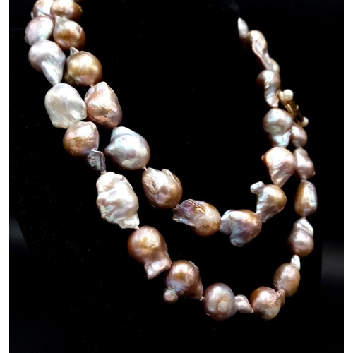 46 - A Vintage Matinee Length Baroque Pearl Necklace with a 14K Gold (tested) Clasp. Fantastic quality pe... 