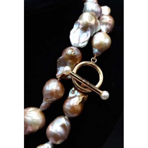 46 - A Vintage Matinee Length Baroque Pearl Necklace with a 14K Gold (tested) Clasp. Fantastic quality pe... 