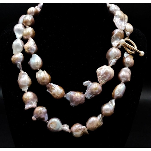 46 - A Vintage Matinee Length Baroque Pearl Necklace with a 14K Gold (tested) Clasp. Fantastic quality pe... 