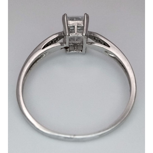 484 - A 9K White Gold CZ Ring. Size R. 1.8g total weight.