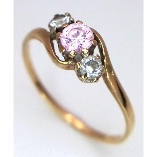 490 - A 9K Yellow Gold Pink and White Stone Crossover Ring. Size P. 1.3g total weight.