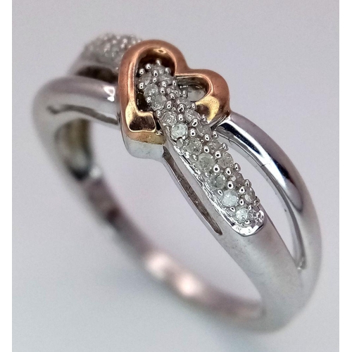 519 - A 9K White and Rose Gold Diamond Heart Crossover Ring. 0.10ctw diamonds. Size L. 2.6g total weight.