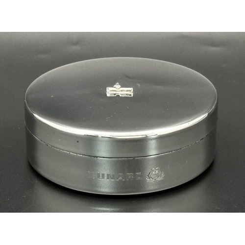 940 - A Cunard Aquascutum White Metal Trinket Box. 8cm diameter. Comes with original pouch and box. Given ... 