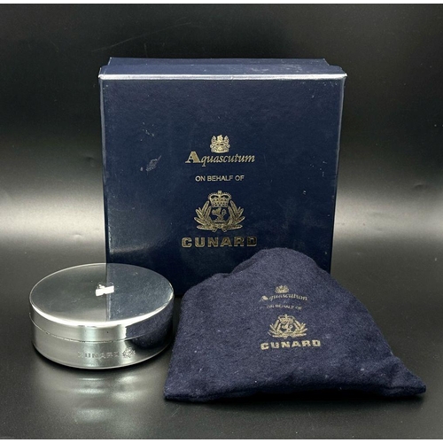 940 - A Cunard Aquascutum White Metal Trinket Box. 8cm diameter. Comes with original pouch and box. Given ... 