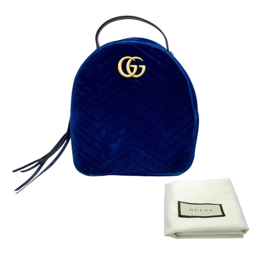 95 - A Gucci Marmont Blue Velvet Backpack. Gold tone hardware. Blue leather straps. Pink textile interior... 