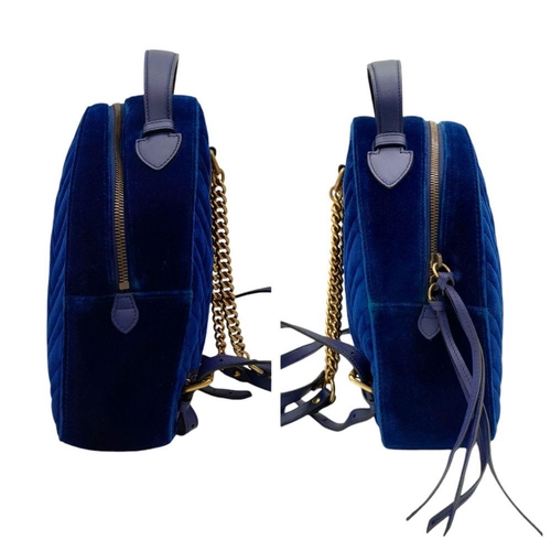 95 - A Gucci Marmont Blue Velvet Backpack. Gold tone hardware. Blue leather straps. Pink textile interior... 