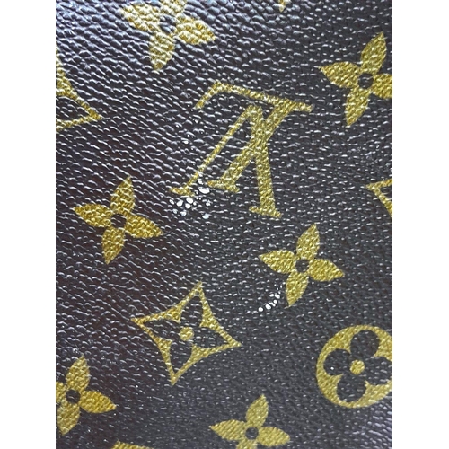 1368 - A Louis Vuitton Keepall 55 Travel Bag. Monogram coated canvas exterior with leather trim, two rolled... 