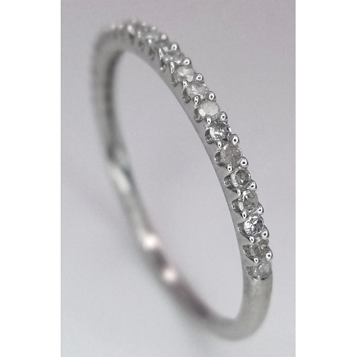 1341 - A 9K WHITE GOLD DIAMOND BAND RING. 0.15CT. 0.7G. SIZE M. A/S SC7.