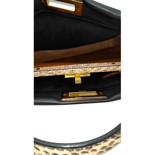 4 - A Fendi Peekaboo Bag. Black leather exterior with multi-colour eyelets and 'Love' fob. Gold tone har... 