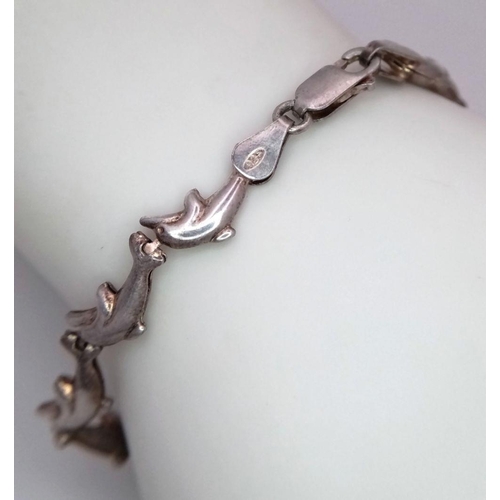 1349 - A STERLING SILVER DOLPHIN LINKS BRACELET - 5.9G. SC3079.