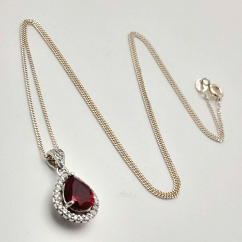 913 - A Sterling Silver Ruby and Clear Stone Pendant Necklace. 51cm Sterling Silver Chain. Sterling Silver... 