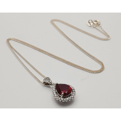 913 - A Sterling Silver Ruby and Clear Stone Pendant Necklace. 51cm Sterling Silver Chain. Sterling Silver... 