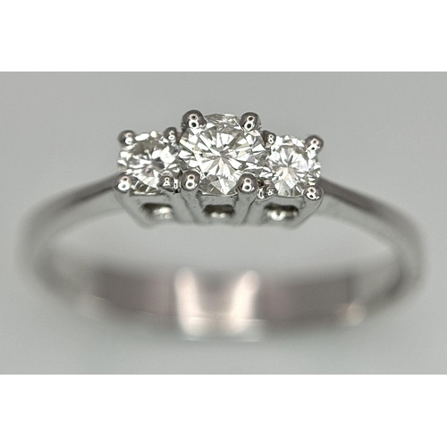 1162 - AN 18K WHITE GOLD DIAMOND 3 STONE RING. 0.40CTW. 3.1G. SIZE P. BLUND4005.