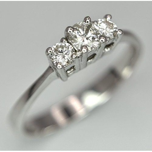 1162 - AN 18K WHITE GOLD DIAMOND 3 STONE RING. 0.40CTW. 3.1G. SIZE P. BLUND4005.