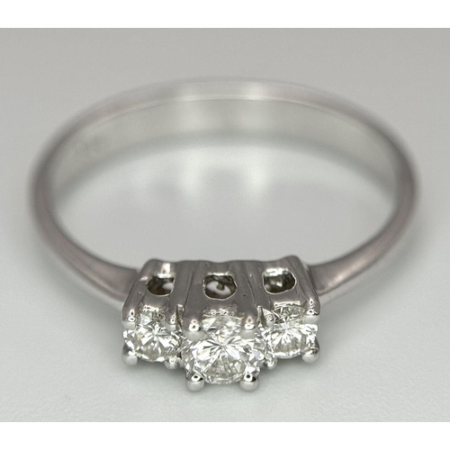 1162 - AN 18K WHITE GOLD DIAMOND 3 STONE RING. 0.40CTW. 3.1G. SIZE P. BLUND4005.